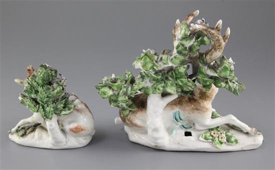 Two Derby porcelain models of recumbent stags, c.1765, 18cm and 11.5cm, some losses and slight restoration